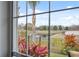 Backyard view showcasing serene pond, mature landscaping, and fenced perimeter at 18819 Sunterra Dr, Land O Lakes, FL 34638