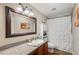 Bathroom with a framed mirror, granite counters, and a shower with a curtain at 18819 Sunterra Dr, Land O Lakes, FL 34638