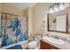 Charming bathroom with a turtle-themed shower curtain and beach decor at 18819 Sunterra Dr, Land O Lakes, FL 34638