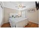 Bright bedroom features a white bedframe, wood flooring, and neutral walls at 18819 Sunterra Dr, Land O Lakes, FL 34638
