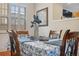 Close-up of the dining table, showing its floral patterned tablecloth and decorative centerpiece at 18819 Sunterra Dr, Land O Lakes, FL 34638