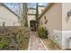 Inviting front entrance with brick walkway and decorative landscaping features at 18819 Sunterra Dr, Land O Lakes, FL 34638