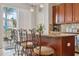 A kitchen with a granite countertop island with chairs and stainless appliances at 18819 Sunterra Dr, Land O Lakes, FL 34638