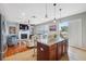 Open living room area with a large kitchen island, fireplace, and hardwood floors at 18819 Sunterra Dr, Land O Lakes, FL 34638
