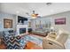 Spacious living room featuring a fireplace, modern furniture, hardwood floors, and a ceiling fan at 18819 Sunterra Dr, Land O Lakes, FL 34638