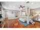 Bright and airy main bedroom featuring hardwood floors, tray ceiling, and a four-poster bed at 18819 Sunterra Dr, Land O Lakes, FL 34638
