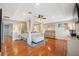 Open, bright main bedroom featuring tray ceiling, hardwood floors, and a four-poster bed at 18819 Sunterra Dr, Land O Lakes, FL 34638