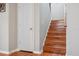 Wooden stairway with white trim and wood flooring at 18819 Sunterra Dr, Land O Lakes, FL 34638