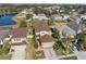 Neighborhood homes with well-maintained lawns, tropical trees, and community lake views at 18819 Sunterra Dr, Land O Lakes, FL 34638