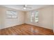 Well-lit bedroom with wood floors and three sunny windows at 10841 Piccadilly Rd, Port Richey, FL 34668