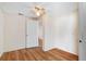 Bedroom with wood floors and ceiling fan at 10841 Piccadilly Rd, Port Richey, FL 34668