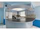 Stylish kitchen featuring a unique island, stainless steel appliances, and white cabinetry at 10841 Piccadilly Rd, Port Richey, FL 34668