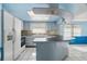 Bright kitchen with an island bar, white cabinets, and modern appliances at 10841 Piccadilly Rd, Port Richey, FL 34668