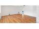 Spacious room with laminate flooring, bright white walls, and a view into the next room at 10841 Piccadilly Rd, Port Richey, FL 34668