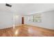 Bright and airy living room with wood laminate flooring and large windows for ample natural light at 10841 Piccadilly Rd, Port Richey, FL 34668