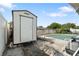 Shed with a white door, located near the pool in the backyard at 10841 Piccadilly Rd, Port Richey, FL 34668