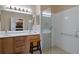 Bright bathroom with a glass enclosed shower, double sink vanity, and accessible features for ease of use at 11008 Torrey Pines Ct, Hudson, FL 34667