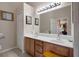 Well-lit bathroom featuring a double sink vanity, a large mirror, and accessibility features for ease of use at 11008 Torrey Pines Ct, Hudson, FL 34667
