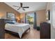 Cozy bedroom with ceiling fan, and a view through the window, providing a comfortable private space at 11008 Torrey Pines Ct, Hudson, FL 34667