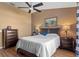 Comfortable bedroom with wood flooring, a ceiling fan, and neutral walls, creating a cozy and inviting atmosphere at 11008 Torrey Pines Ct, Hudson, FL 34667