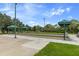 Bocce ball courts with green surface, concrete surrounds, sun shades, and landscaping at 11008 Torrey Pines Ct, Hudson, FL 34667