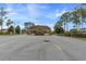 Community entrance with brick guard house, landscaping, and signage at 11008 Torrey Pines Ct, Hudson, FL 34667