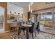 Dining area with modern light fixtures, access to the patio, and an adjacent kitchen at 11008 Torrey Pines Ct, Hudson, FL 34667