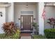 This home features a covered entryway with brick columns, sidelights, and stylish planters at 11008 Torrey Pines Ct, Hudson, FL 34667