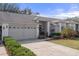 Landscaped front yard leads to this house with neutral-colored brick accents, a two-car garage, and covered entry at 11008 Torrey Pines Ct, Hudson, FL 34667