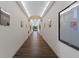 Long hallway with elegant lighting and décor, providing a welcoming and well-maintained passage at 11008 Torrey Pines Ct, Hudson, FL 34667