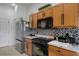 Kitchen features a stainless steel refrigerator, oven, and granite countertops at 11008 Torrey Pines Ct, Hudson, FL 34667