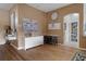 Open living space with hardwood floors, an arched entryway and pantry access at 11008 Torrey Pines Ct, Hudson, FL 34667