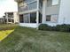Exterior view of condo with lawn and screened balcony at 12408 Eagleswood Dr # B, Hudson, FL 34667