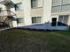 Lawn and patio view of condo building, with walkout, and balconies above at 12408 Eagleswood Dr # B, Hudson, FL 34667