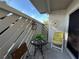 Charming condo balcony with table, chairs, decor, and sliding glass door at 12408 Eagleswood Dr # B, Hudson, FL 34667
