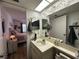 Bathroom with a decorative mirror and countertop, connected to the main bedroom at 12408 Eagleswood Dr # B, Hudson, FL 34667