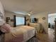 Bedroom featuring wood laminate floors, natural light, and a view to the living room at 12408 Eagleswood Dr # B, Hudson, FL 34667