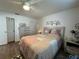 Bedroom with a ceiling fan, wood laminate flooring, and a comfortable bed at 12408 Eagleswood Dr # B, Hudson, FL 34667