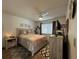 Bedroom showcasing wood laminate flooring, ceiling fan, a dresser and a window at 12408 Eagleswood Dr # B, Hudson, FL 34667