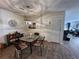 Dining area features wood flooring, decorative lighting fixture, and view of the living area at 12408 Eagleswood Dr # B, Hudson, FL 34667