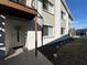 Exterior view of condo building featuring garden and stairs to unit at 12408 Eagleswood Dr # B, Hudson, FL 34667