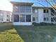 Condo exterior showcasing a screened in porch on the bottom level and a balcony on the upper level at 12408 Eagleswood Dr # B, Hudson, FL 34667
