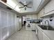 Bright kitchen features white appliances, ample cabinet space, and tile flooring at 12408 Eagleswood Dr # B, Hudson, FL 34667
