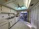 Bright kitchen features white appliances, ample cabinet space, and sliding door access to patio at 12408 Eagleswood Dr # B, Hudson, FL 34667