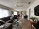 Spacious living room featuring neutral paint, wood laminate flooring, and an open floor plan at 12408 Eagleswood Dr # B, Hudson, FL 34667