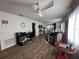 Living area with laminate wood flooring, ceiling fan, and a view to the screened in porch in the background at 12408 Eagleswood Dr # B, Hudson, FL 34667