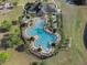 Bird's-eye view of the resort style pool, amenities, and lush landscaping at 13357 Marble Sands Ct, Hudson, FL 34669