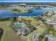 Community aerial view with a pool, playground, lake, and residential area at 13357 Marble Sands Ct, Hudson, FL 34669