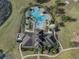 Aerial view of the pool with intricate design, surrounded by lush greenery at 13357 Marble Sands Ct, Hudson, FL 34669