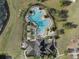 Top-down aerial view of the community pool with ample seating and surrounding landscape at 13357 Marble Sands Ct, Hudson, FL 34669